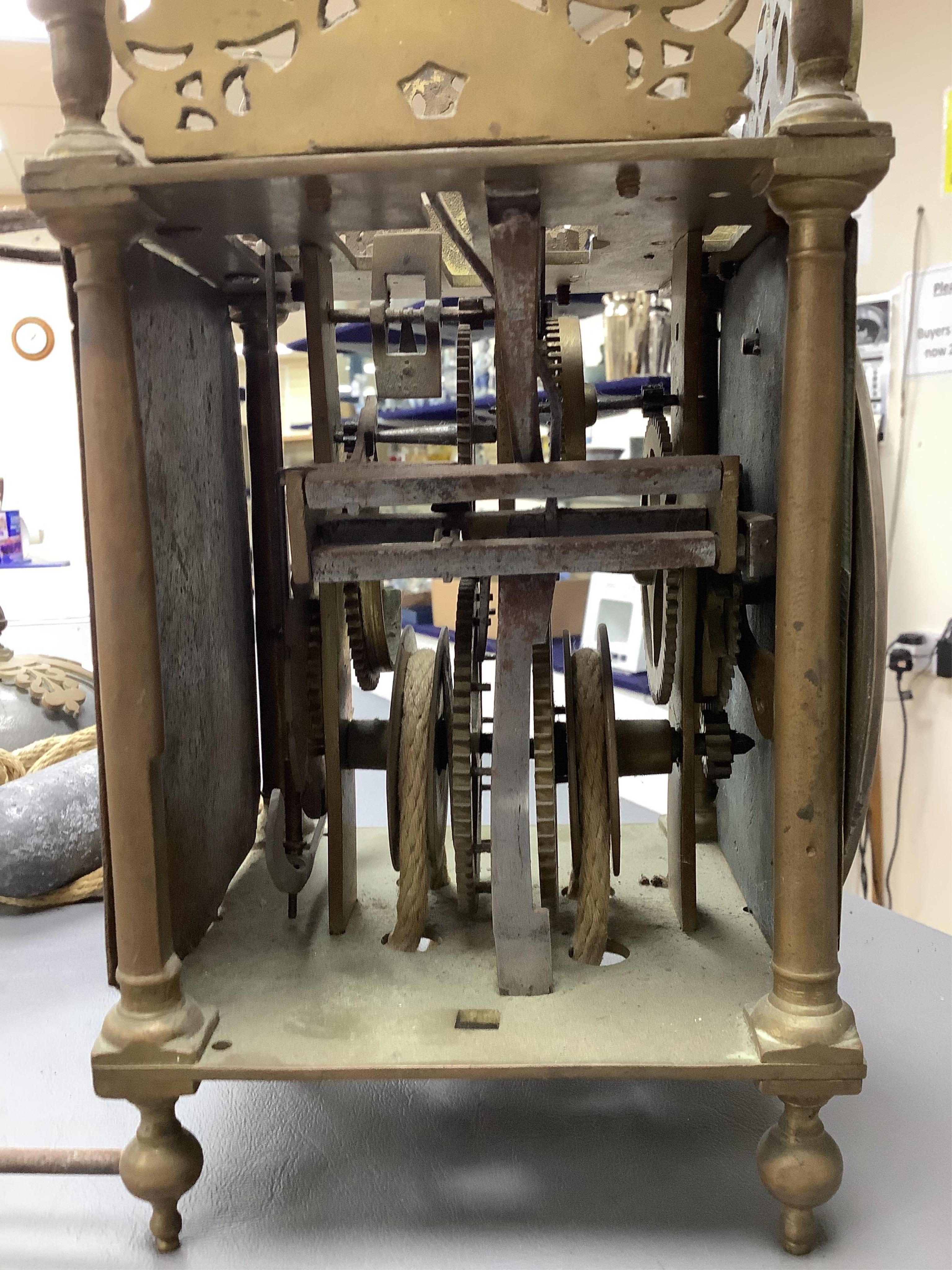 R. Arnold, Bodmin, a lantern clock on wooden wall shelf, clock 32cm high